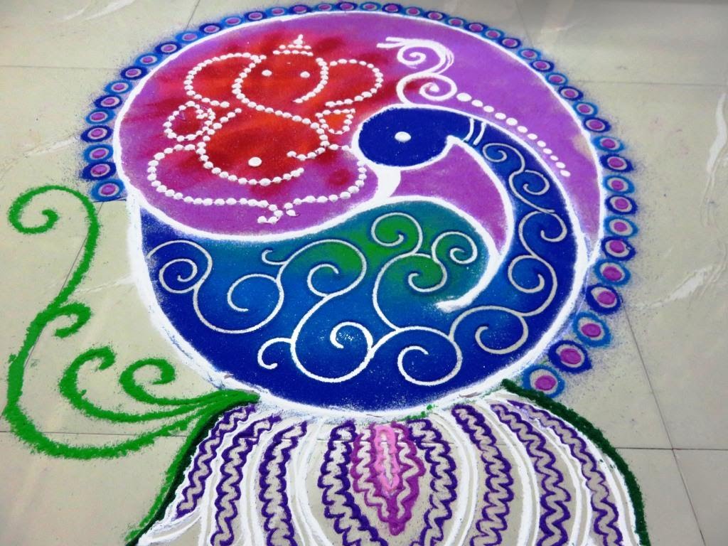 Ganesha above peacock rangoli