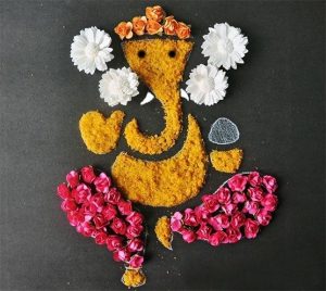 Ganesh rangoli with real and artificial flowers