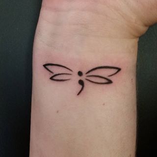 47.Dot comma butterfly tattoo