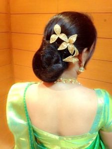 20.lower bun with artificial flower hairstyle