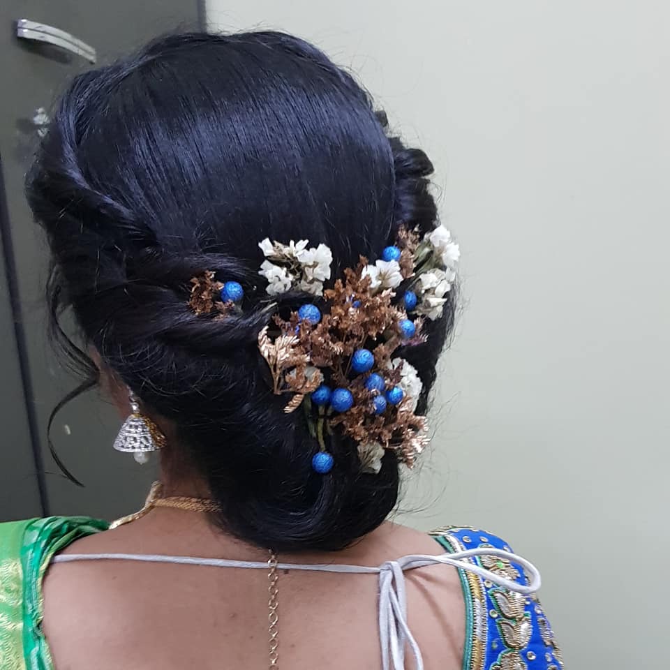 Reception hairstyle  with blue flower