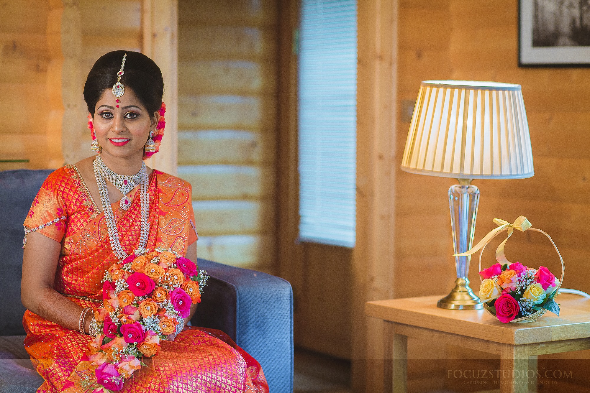 Front bun hairstyle for orange saree