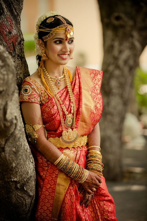 Red kancipuram silk saree with aari work blouse