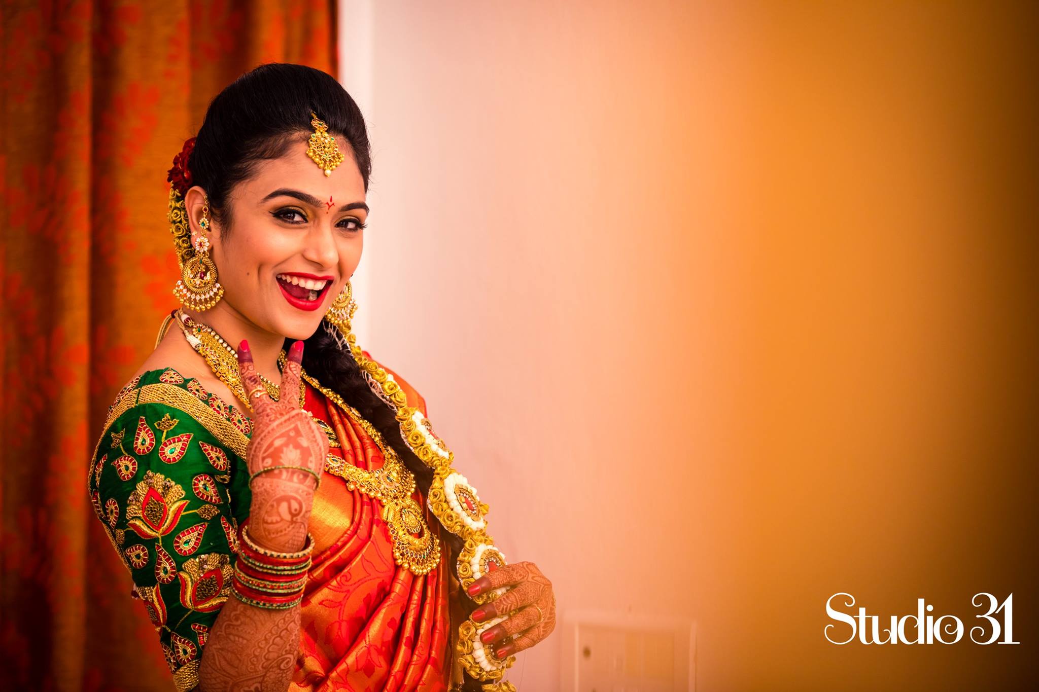 Red silk saree with Green Stine work blouse