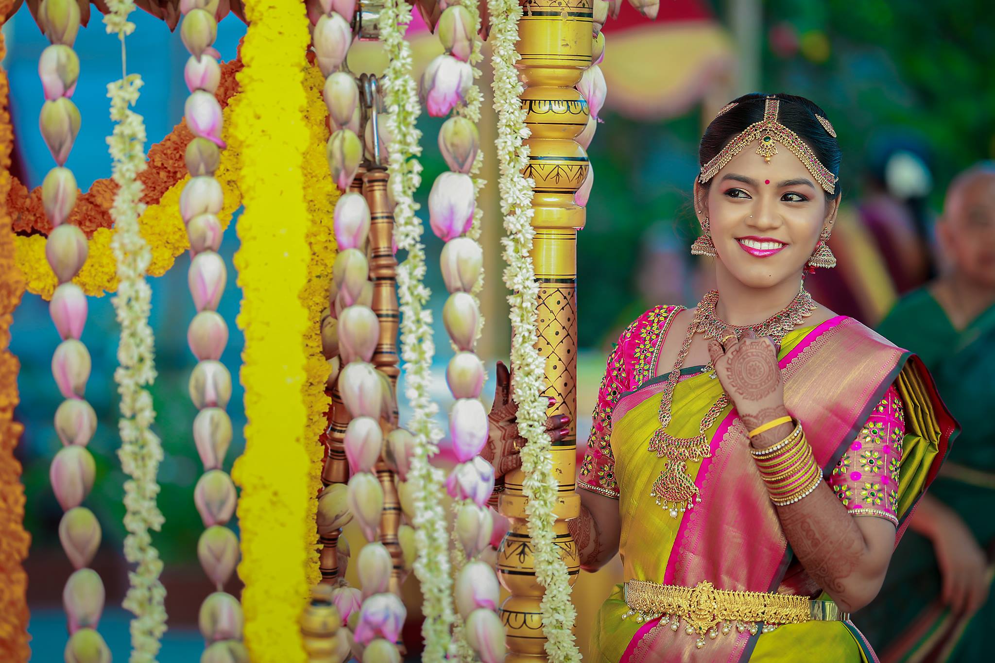 Yellow silk saree with pink and green border