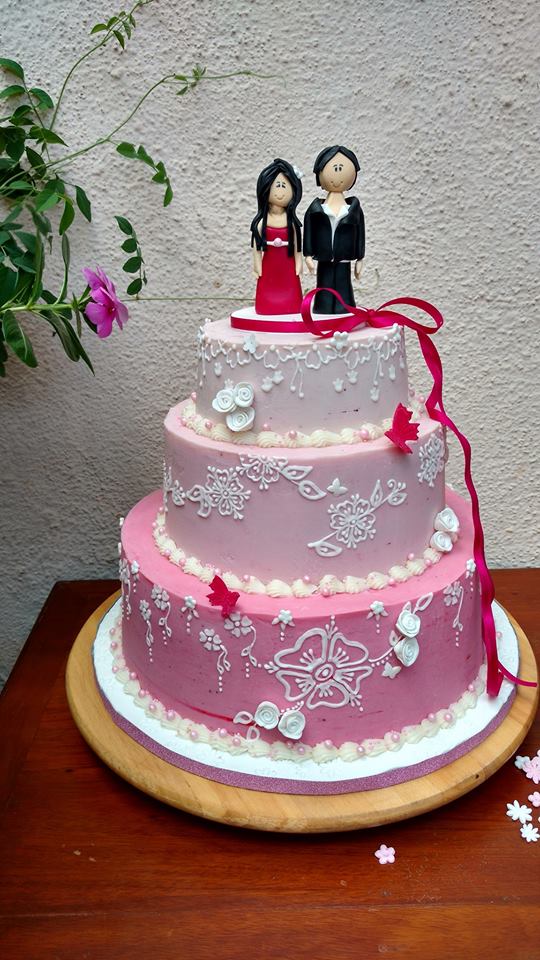 Couple cake with pink ombre effect with delicate white piping 